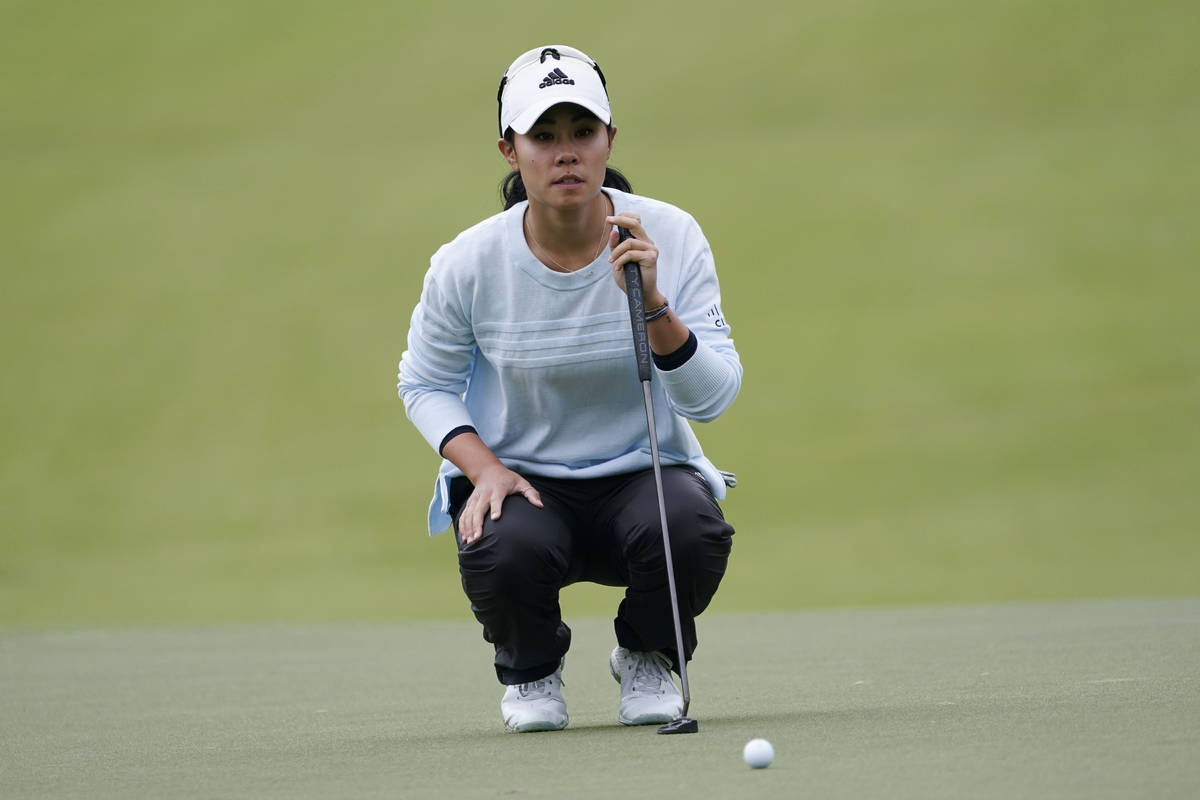 Danielle Kang lines up a putt on the first hole during the third round of the U.S. Women's Open ...