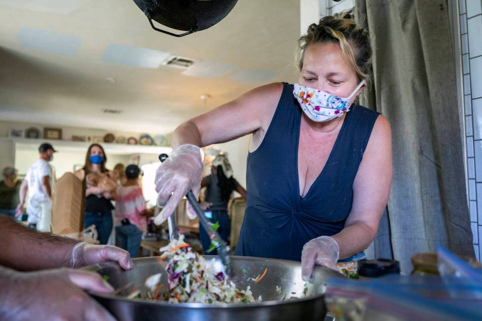 Kim Foster, writer and organizer of the Please Send Noodles cookbook club, prepares coleslaw fo ...