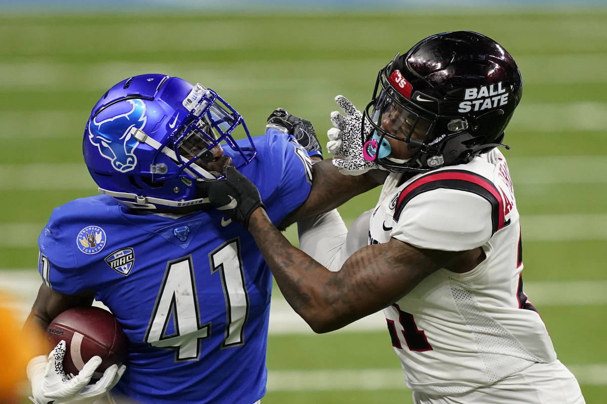 Buffalo wide receiver Antonio Nunn (41) is stopped by Ball State cornerback Antonio Phillips (2 ...