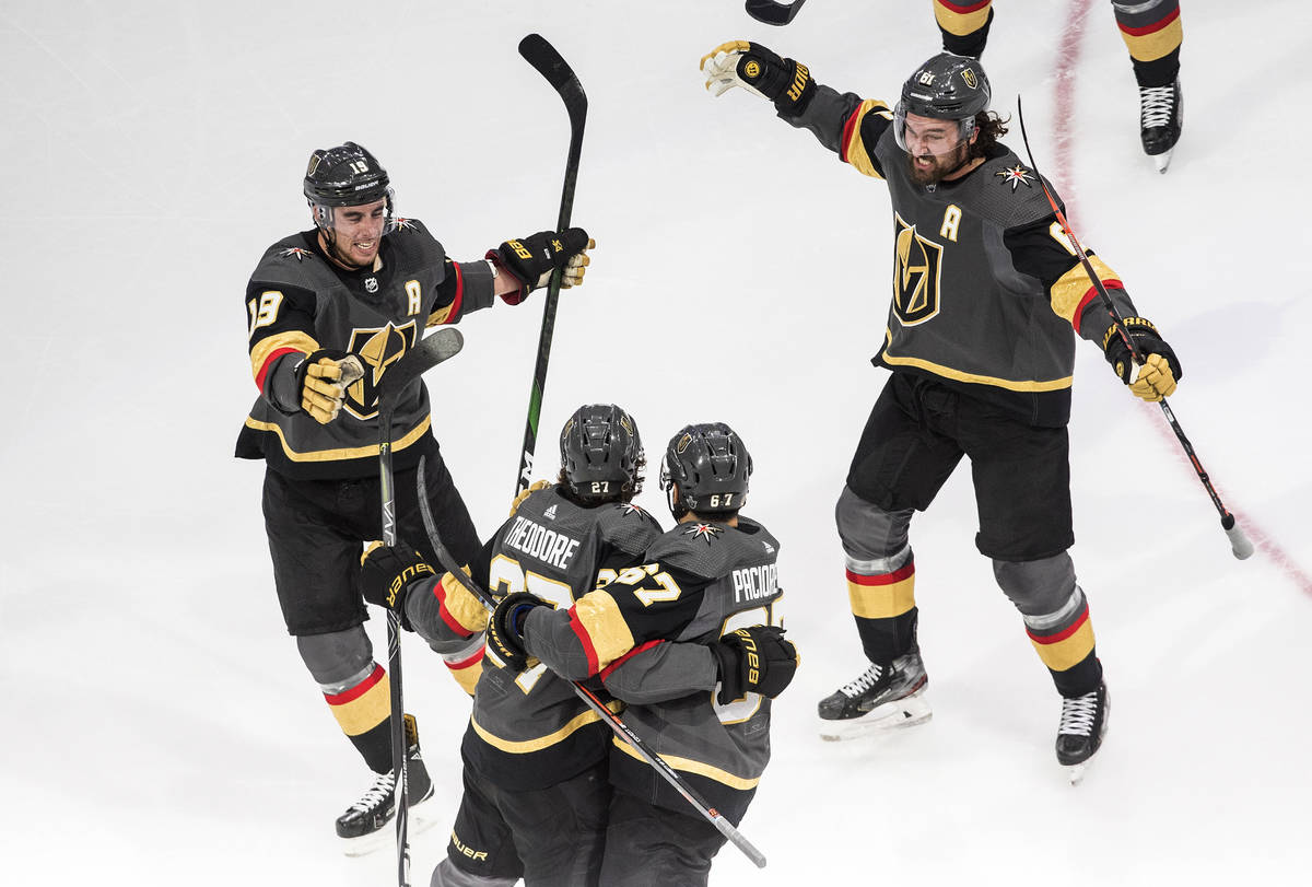 Vegas Golden Knights' Shea Theodore (27) celebrates his goal against the Vancouver Canucks with ...