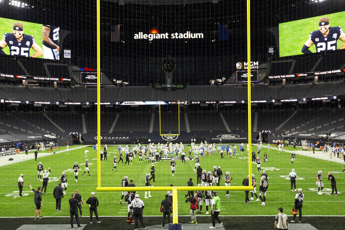 The Raiders and the Chargers warm up in a stadium empty of fans due to the coronavirus pandemic ...