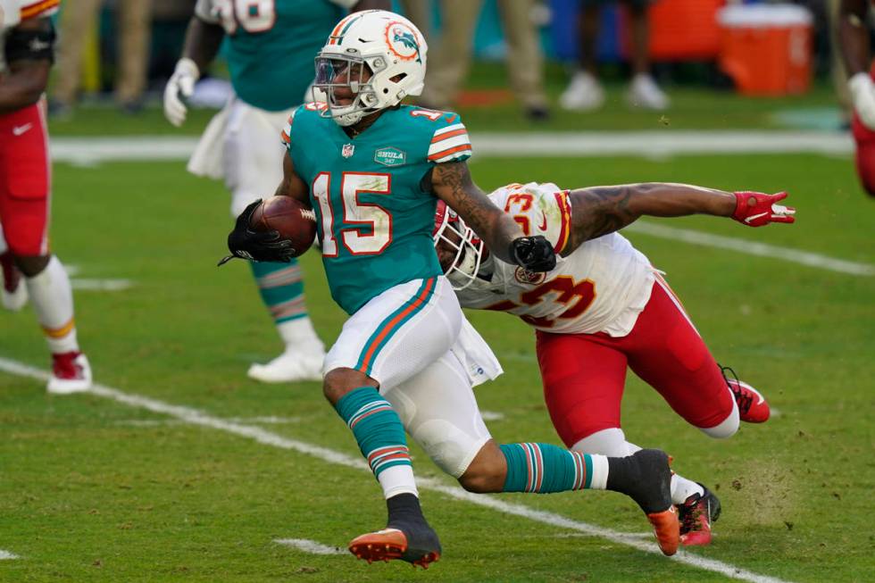 Miami Dolphins running back Lynn Bowden (15) runs away from Kansas City Chiefs middle linebacke ...