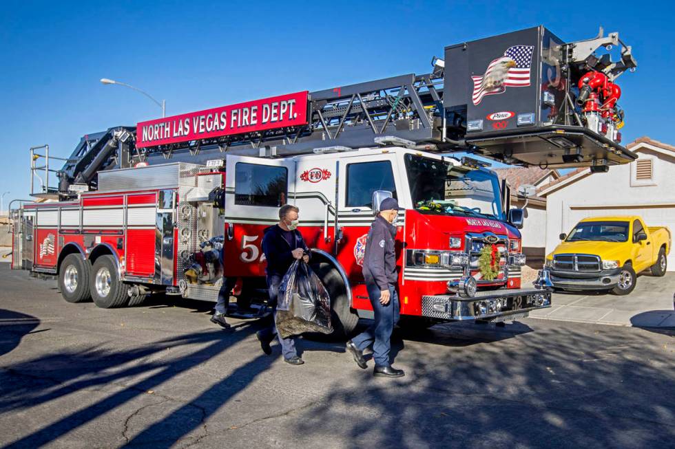 A North Las Vegas Fire Truck 52 crew arrives at a home while delivering Christmas gifts to kids ...