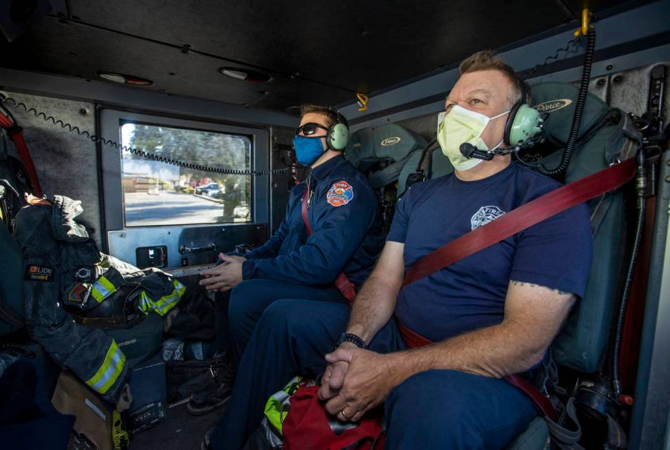 North Las Vegas Fire Truck 52 crew members Tyler Lowry, left, and Pat Johnson make time during ...