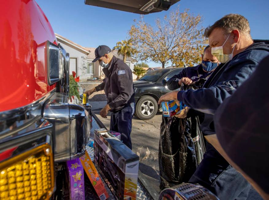 North Las Vegas Fire Truck 52 crew members Brandon Parry, left, Reese Williams, center, and Pat ...