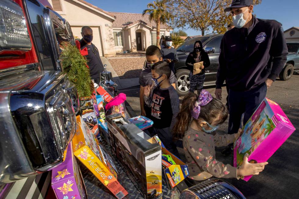 (Clockwise from top right) North Las Vegas Fire Truck 52 crew member Brandon Parry looks on as ...