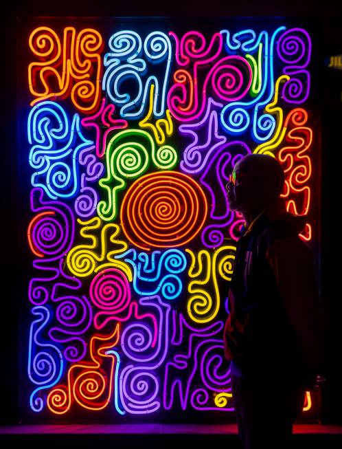 Neon Museum 2020 Artist in Residence Victor Ehikhamenor silhouetted by his piece "Harvesti ...