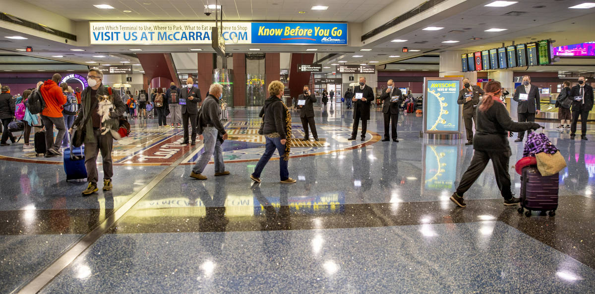 People come and go through baggage at Terminal 1 as holiday travel at McCarran International Ai ...