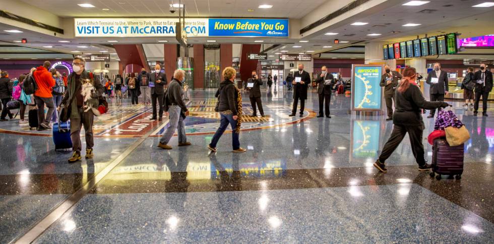 People come and go through baggage at Terminal 1 as holiday travel at McCarran International Ai ...