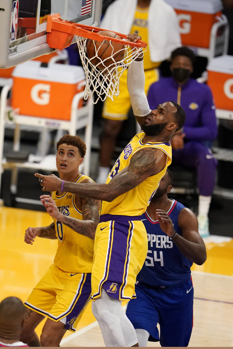 Los Angeles Lakers forward LeBron James dunks against the Los Angeles Clippers during the first ...