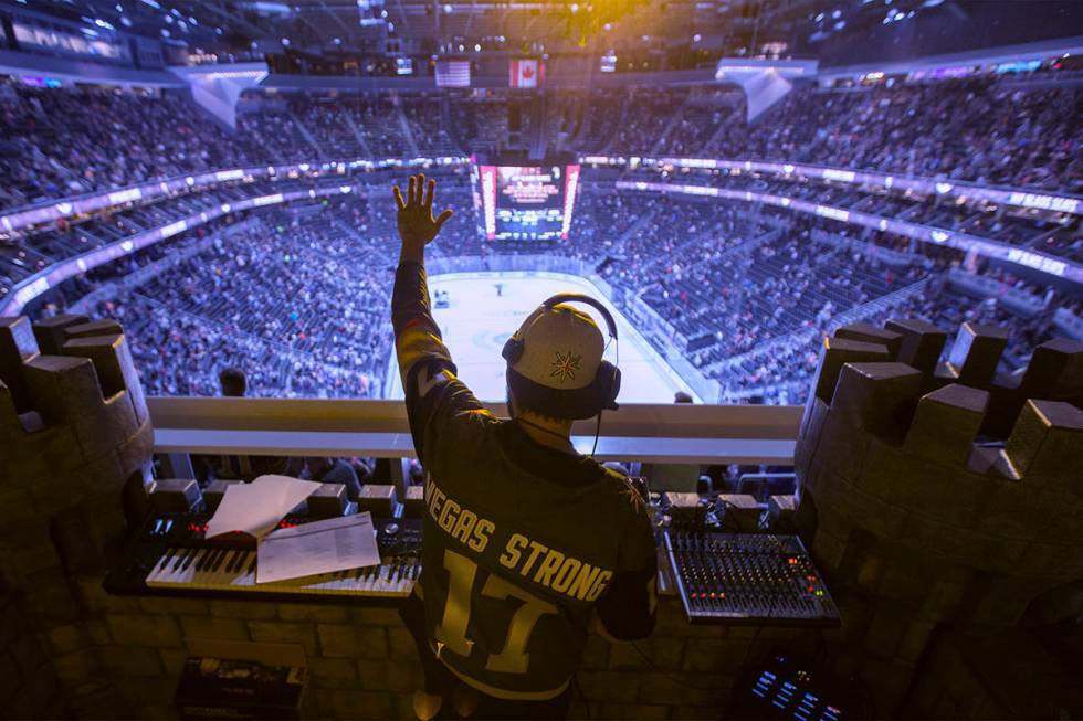 Golden Knights music director Jake Wagner waves to the crowd at the end of the first period dur ...