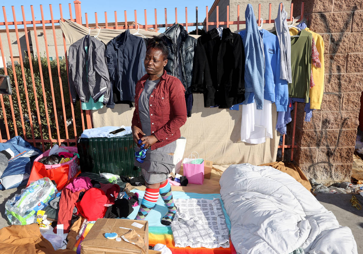 Dashonna Espie talks to a reporter as people line up on Foremaster Lane for a Christmas meal at ...