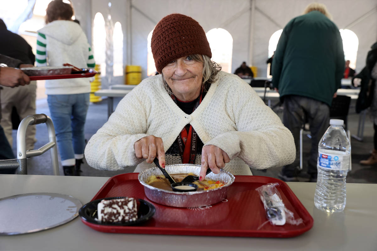 Cindy McCabe, 64, eats a Christmas meal of prime rib with horseradish cream sauce, mashed potat ...