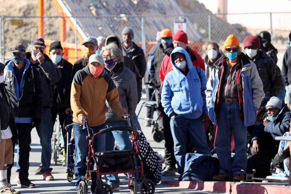 People line up on Foremaster Lane for a Christmas meal at Catholic Charities of Southern Nevada ...