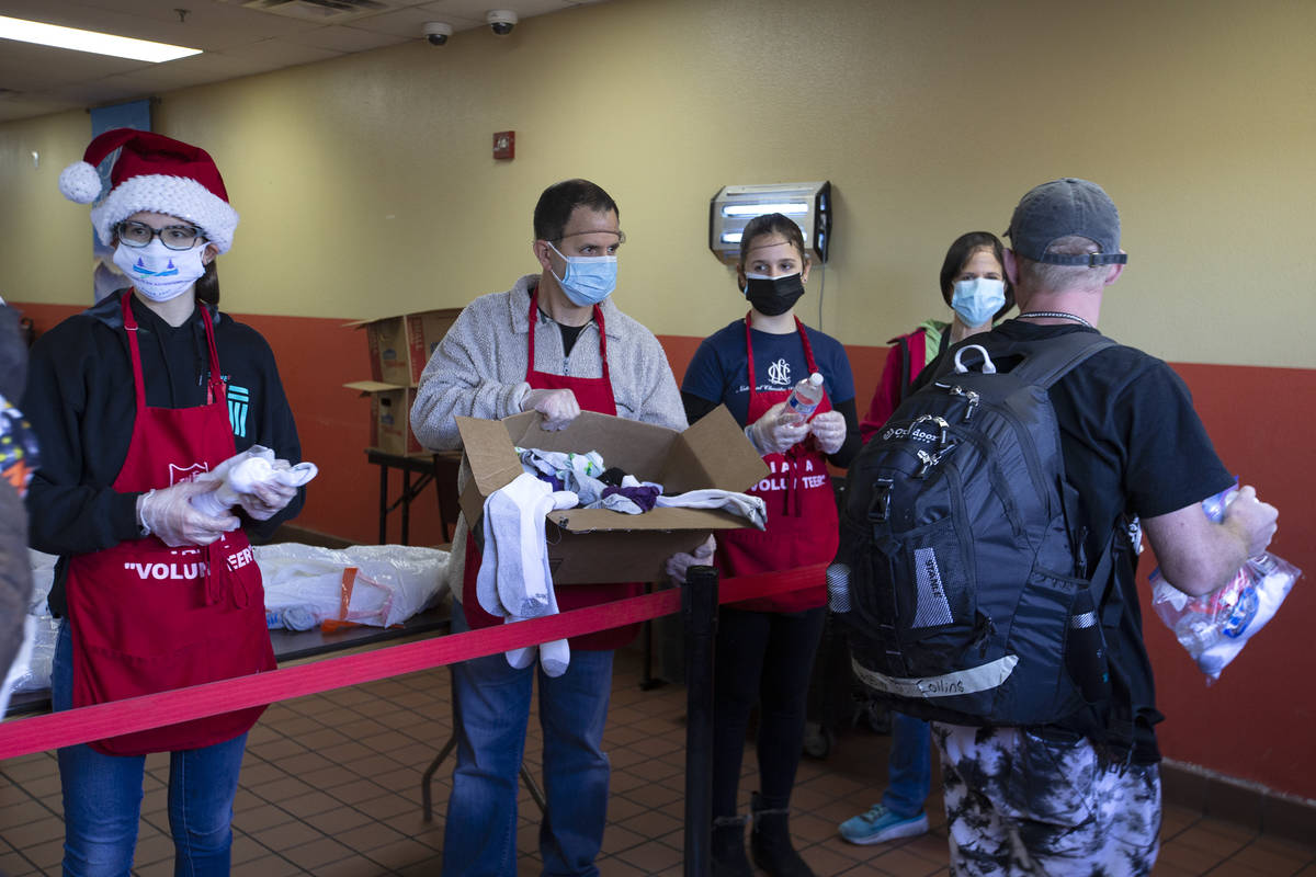 From left, Sage Serenco, Mike Serenco, Bree Serenco and Cheryn Serenco hand out Christmas meals ...