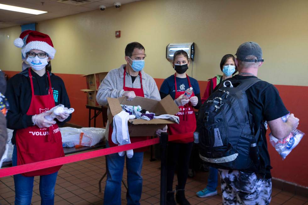 From left, Sage Serenco, Mike Serenco, Bree Serenco and Cheryn Serenco hand out Christmas meals ...