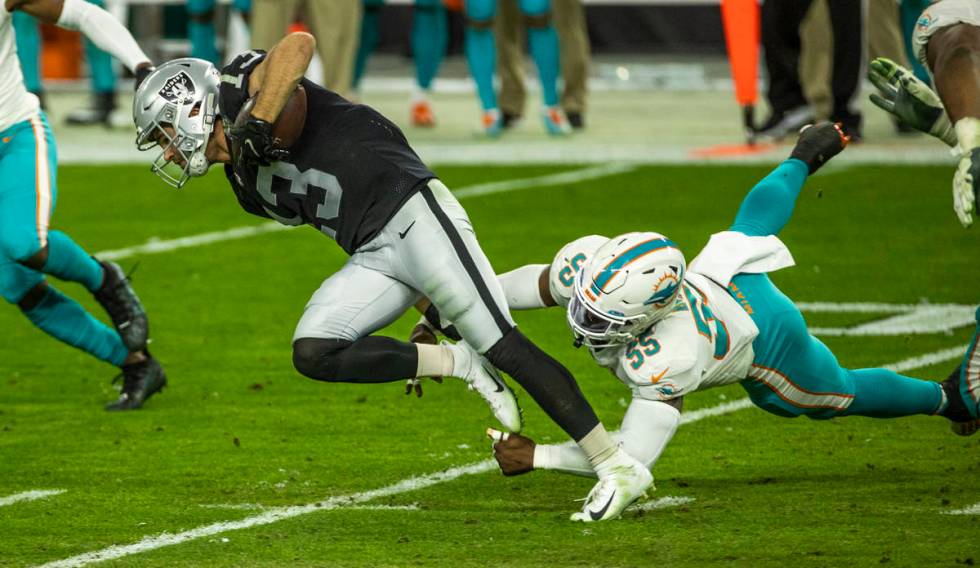 Raiders wide receiver Hunter Renfrow (13) is tripped up from behind by Miami Dolphins outside l ...