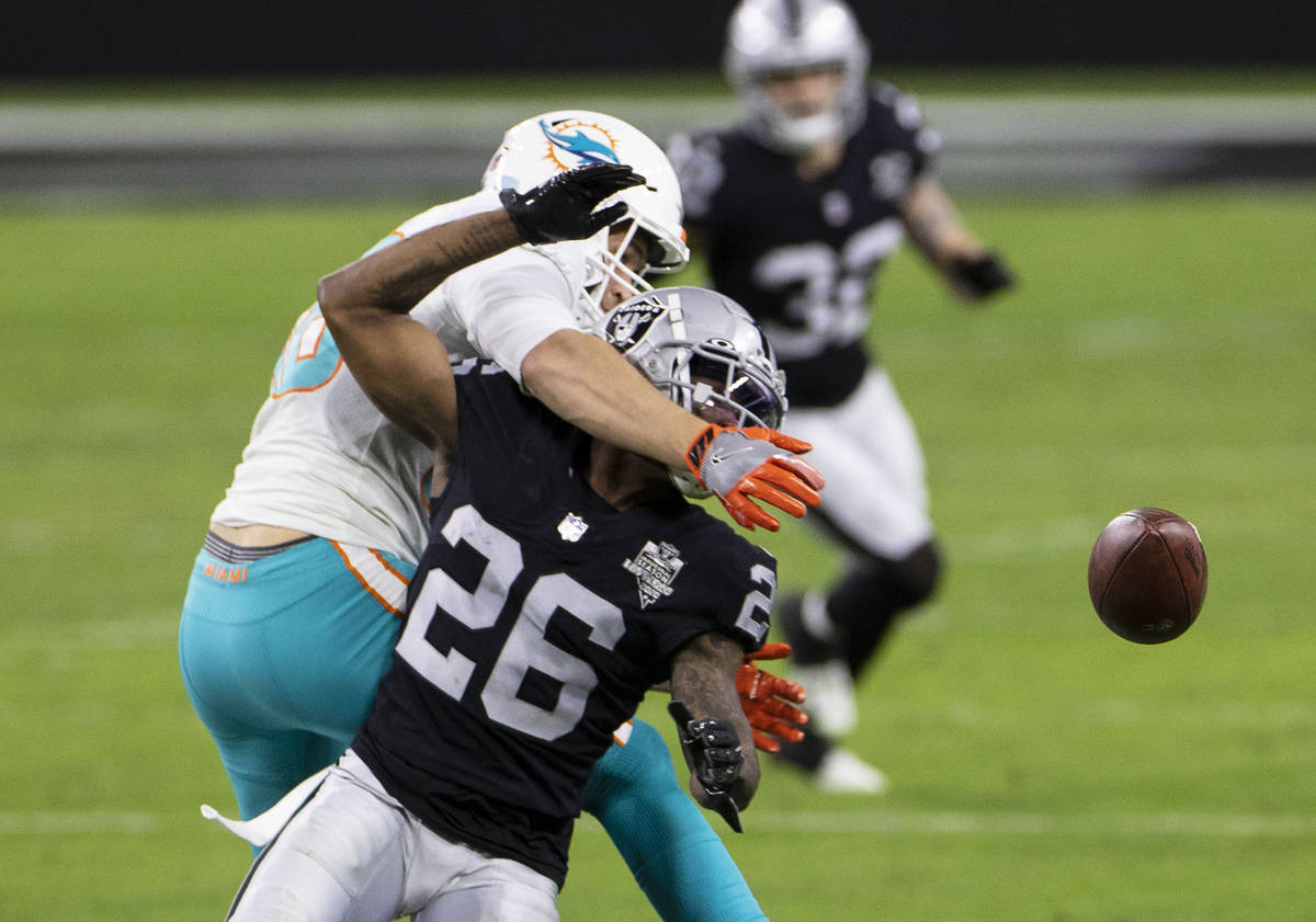 Miami Dolphins tight end Mike Gesicki (88) deflects the ball as Raiders cornerback Nevin Lawson ...