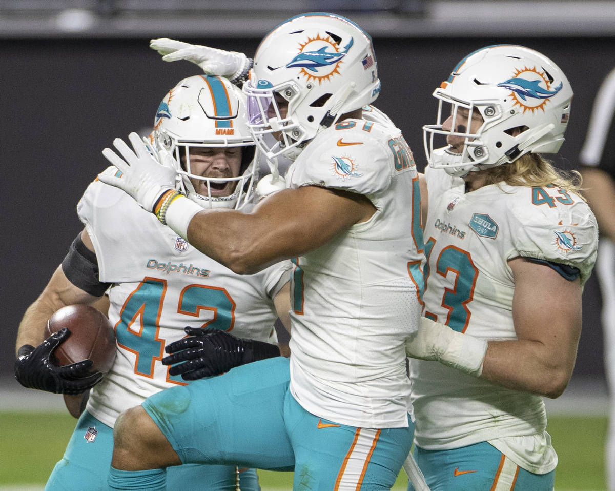 Miami Dolphins defensive back Clayton Fejedelem (42) celebrates a big play with teammates in th ...