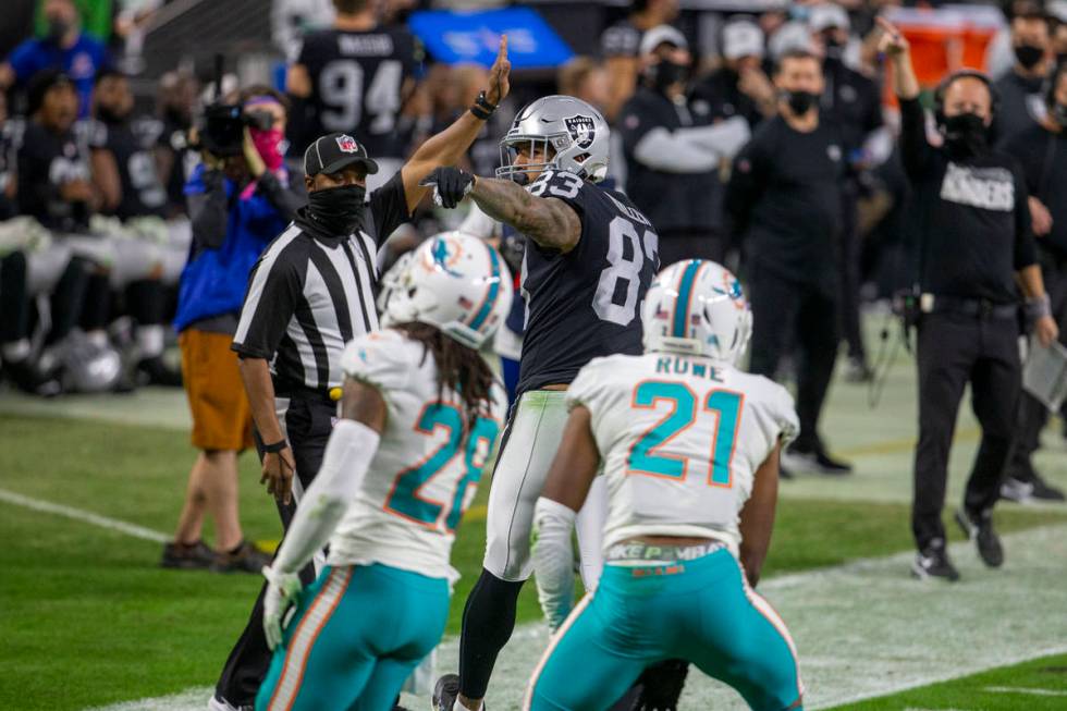 Raiders tight end Darren Waller (83) points for a first down after a catch made over Miami Dolp ...