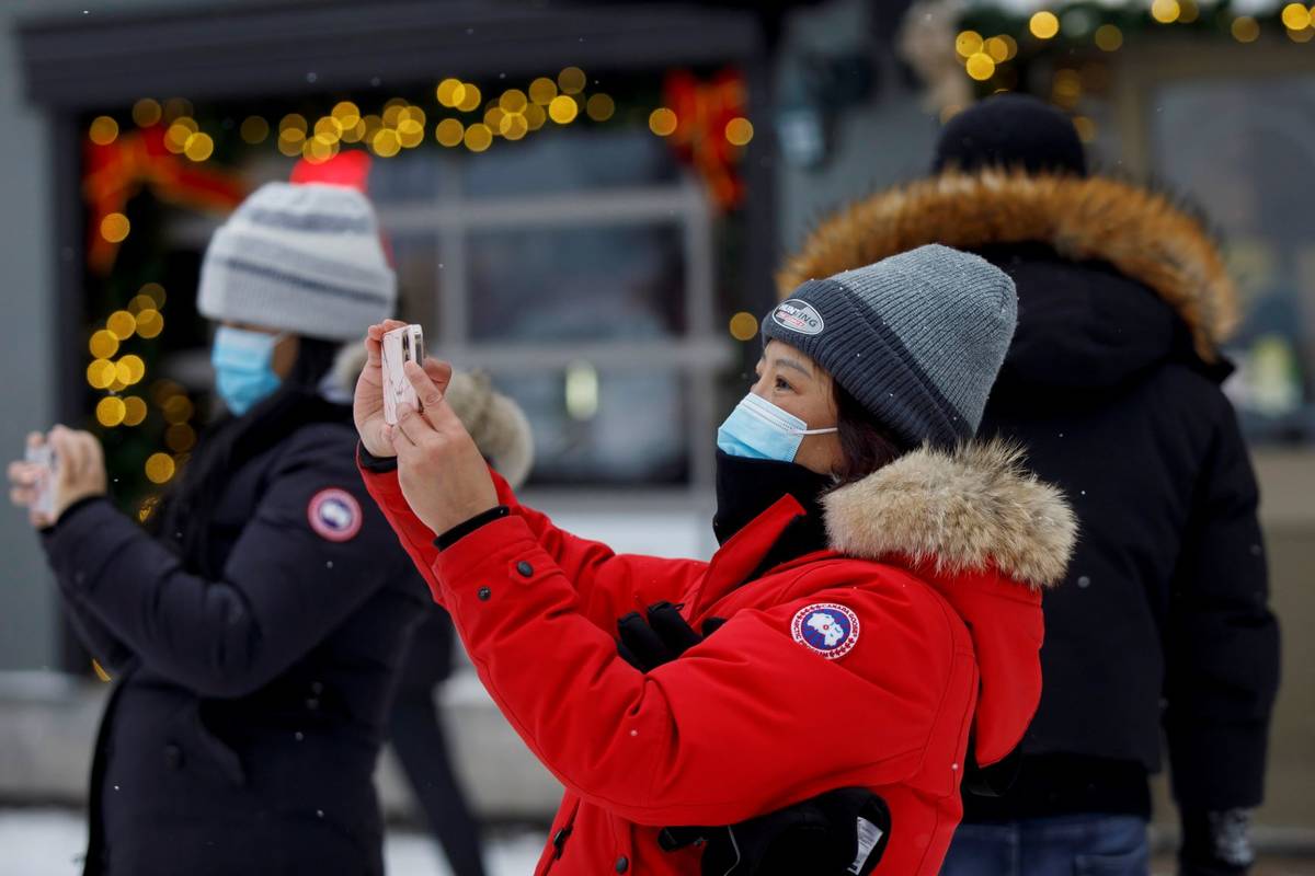 Guests take photos in the village of Blue Mountain Ski Resort in The Blue Mountains, Ontario, o ...