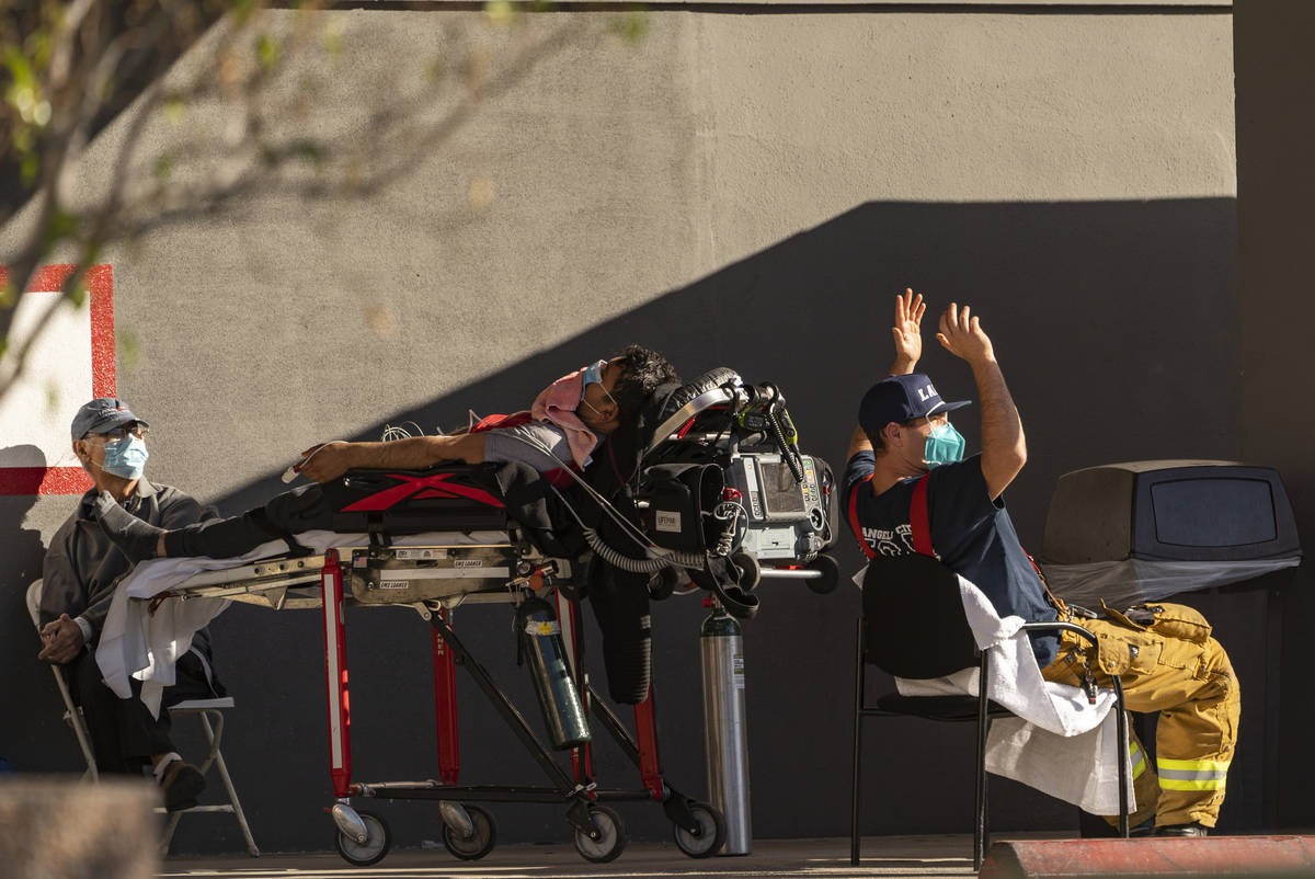 An unidentified patient receives oxygen on a stretcher while Los Angeles Fire Department parame ...