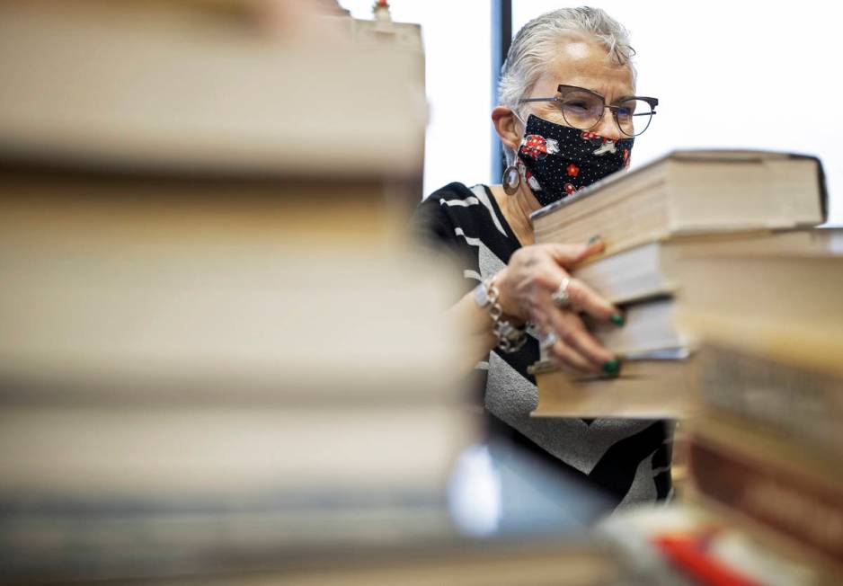 Myrna Donato, owner of Amber Unicorn Books, checks customers out on the last business day at th ...