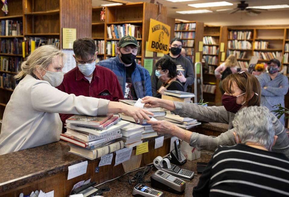 Customers flood the front desk at Amber Unicorn Books on the last business day of the Vegas lan ...