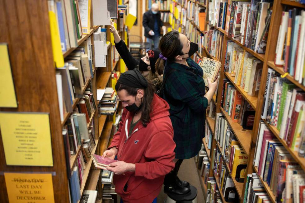 Nicholas Bar, bottom/left, and Jacqueline Lee shop at Amber Unicorn Books on the last business ...