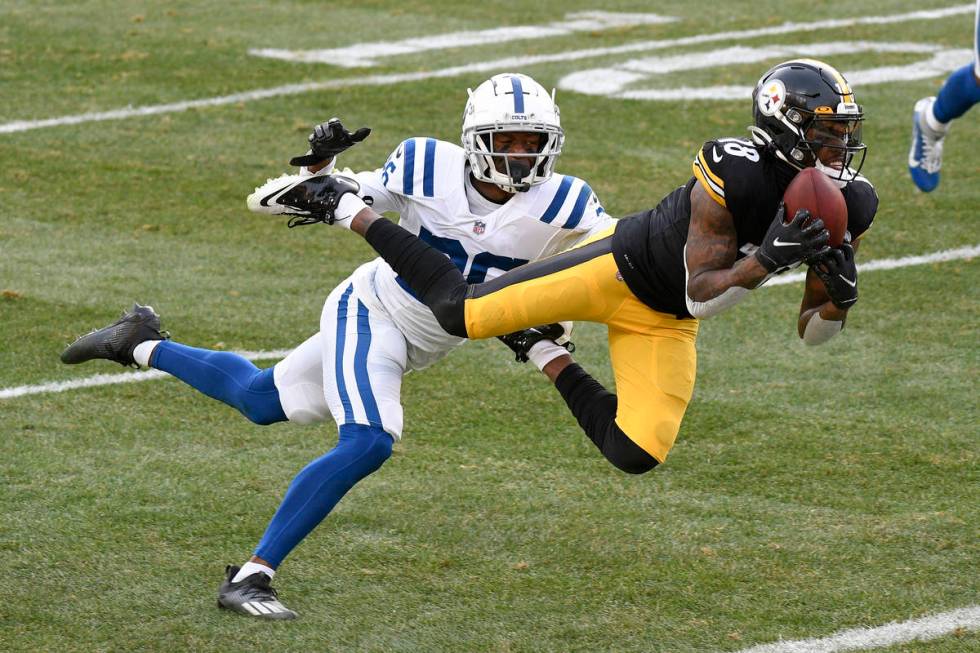Pittsburgh Steelers wide receiver Diontae Johnson (18) makes a catch past Indianapolis Colts co ...
