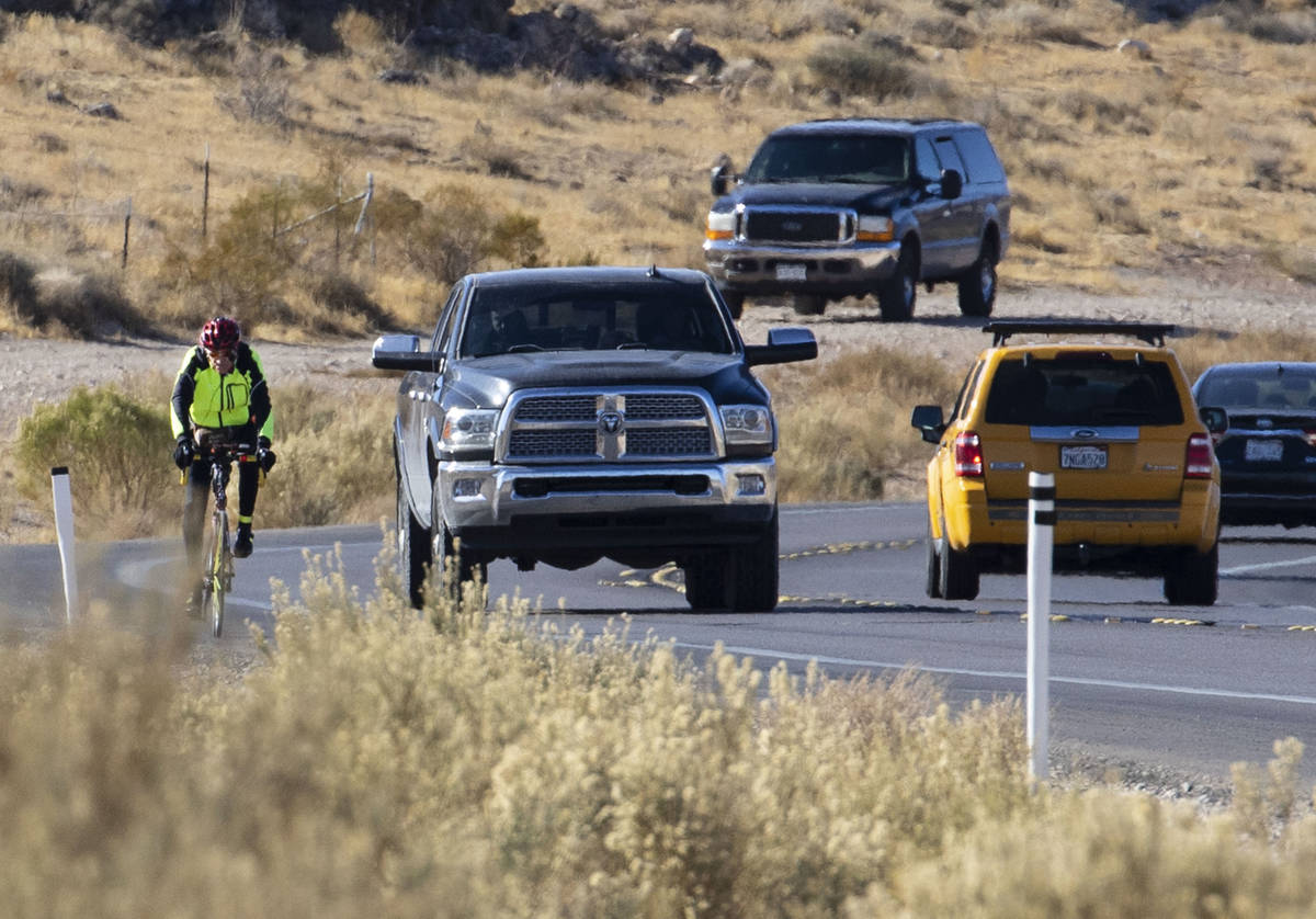 A cyclist rides his bike along the Charleston Blvd near Red Rock, on Tuesday, Dec. 29, 2020, in ...