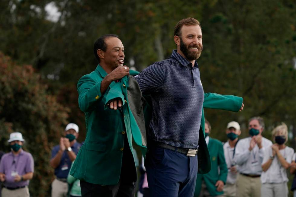 Tiger Woods, left and Dustin Johnson during the final round of the Masters golf tournament Mond ...