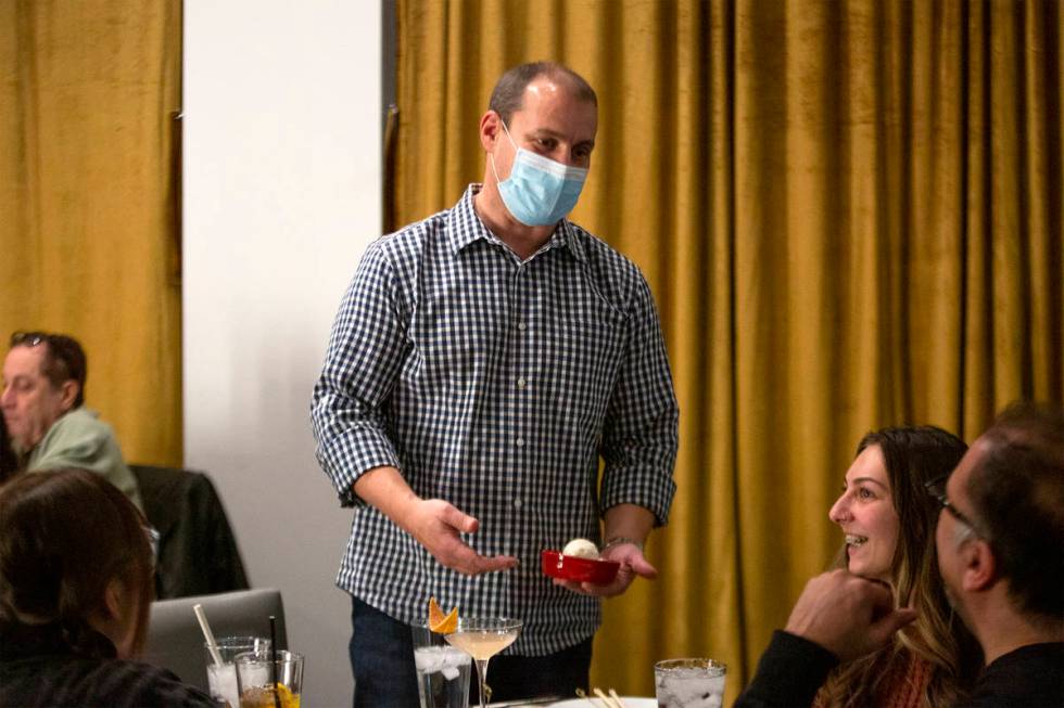 Co-owner of Chinglish Cantonese Wine Bar Ken Heck delivers a dessert to a group of diners on Th ...