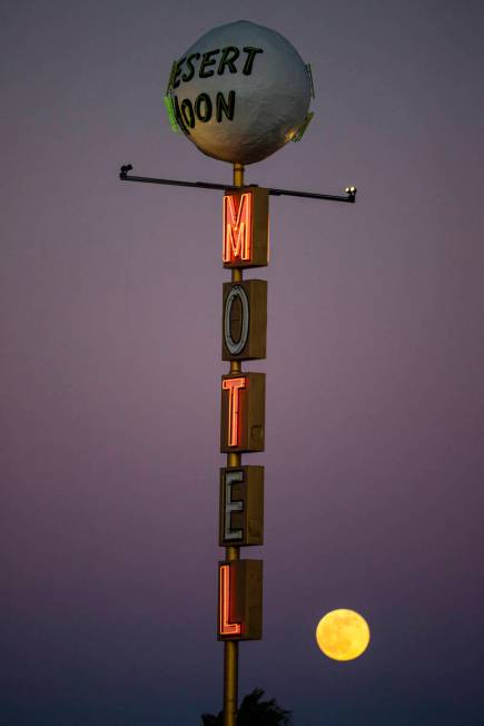 The last full moon of the year rises above the Desert Moon Motel sign on east Fremont Street in ...