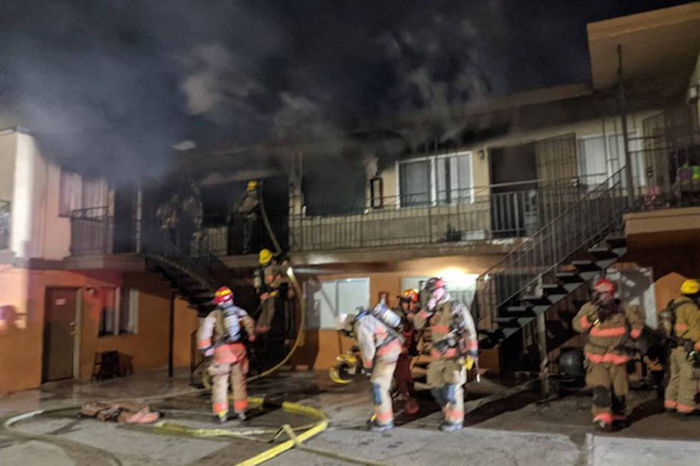 Crews battle a fire Tuesday, Dec. 29, 2020, at 4043 Silver Dollar Ave. in Las Vegas. (Las Vegas ...