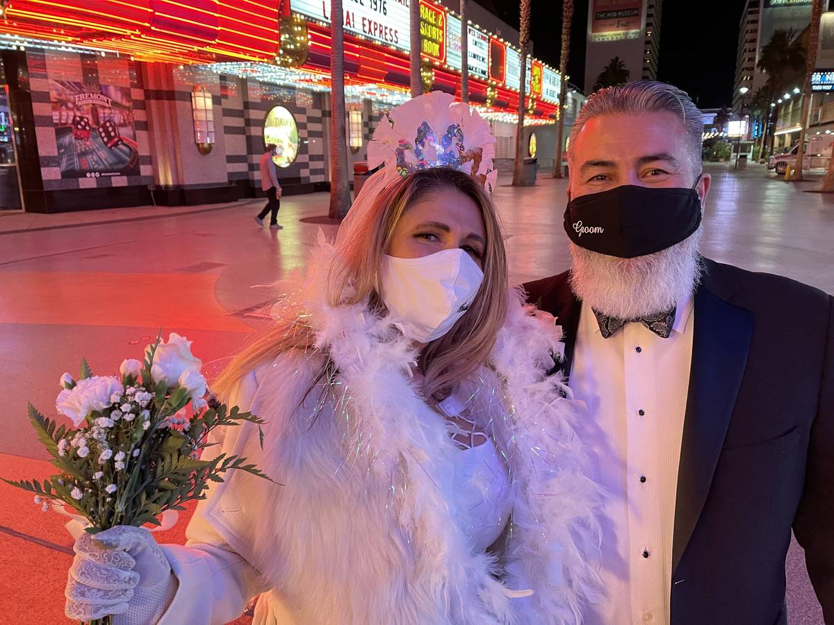 Just-married couple Martha and Robert Pacheco of Las Vegas celebrate New Year's Eve at the Frem ...