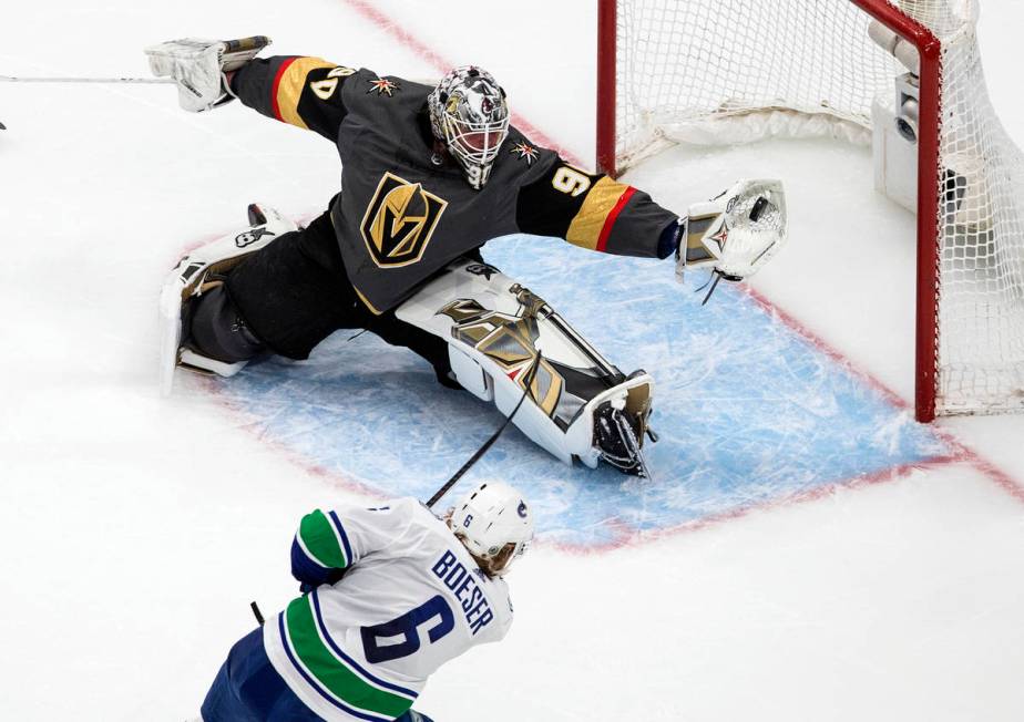 Vancouver Canucks' Brock Boeser (6) is stopped by Vegas Golden Knights goalie Robin Lehner (90) ...