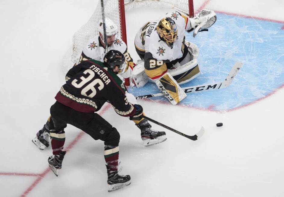 Arizona Coyotes' Christian Fischer (36) is stopped by Vegas Golden Knights goalie Marc-Andre Fl ...