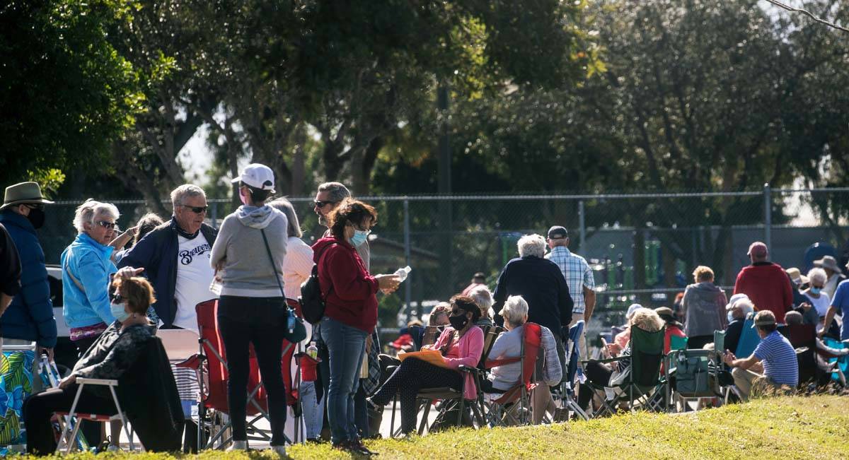 Hundreds of people wait in line Tuesday, Dec. 29, 2020, at the STARS Complex, in Fort Myers, Fl ...