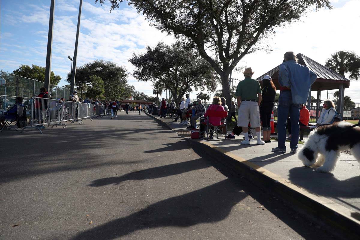 Hundreds of people wait in line Tuesday, Dec. 29, 2020, at the STARS Complex, in Fort Myers, Fl ...