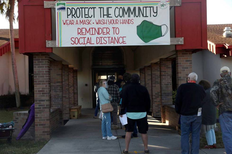 Hundreds of people wait in line Tuesday, Dec. 29, 2020, at the STARS Complex, in Fort Myers, Fl ...