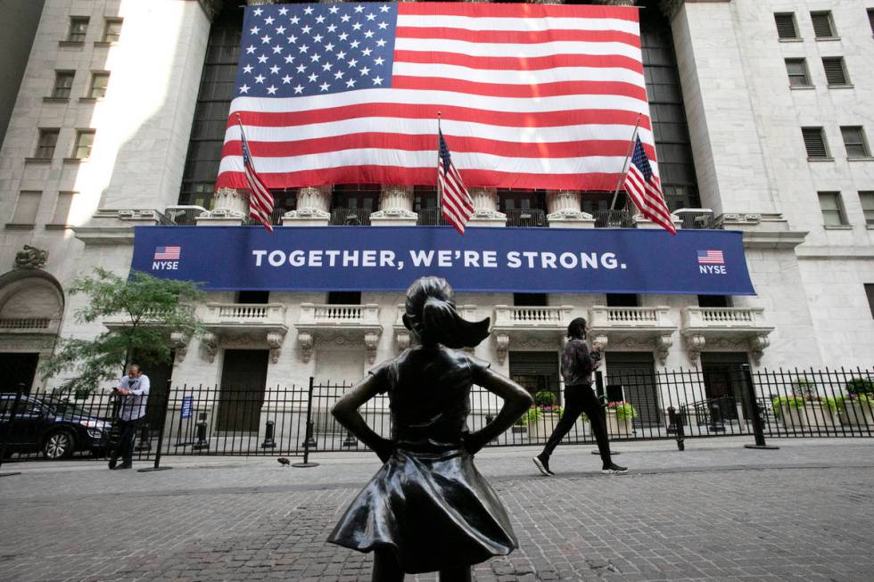 In this July 9, 2020 file photo, the Fearless Girl statue stands in front of the New York Stock ...