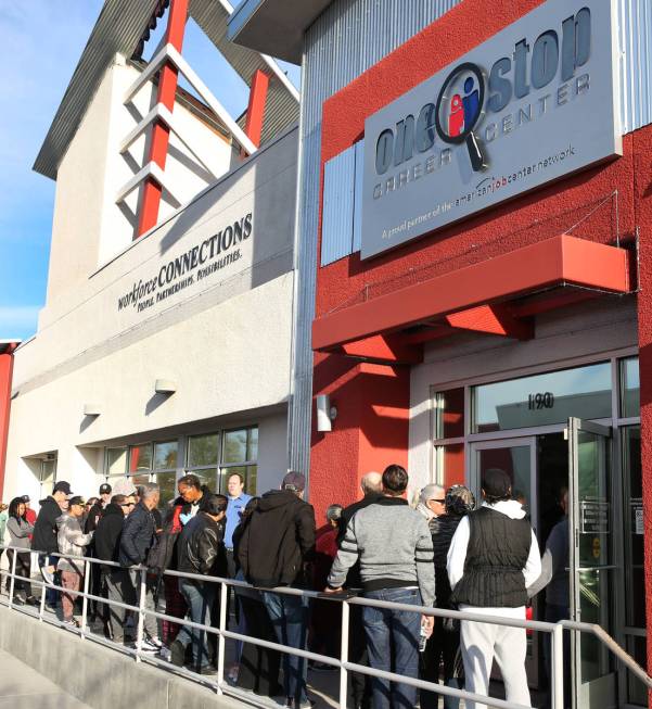 People wait in line at One-Stop Career Center, March 16, 2020, in Las Vegas. (Bizuayehu Tesfaye ...