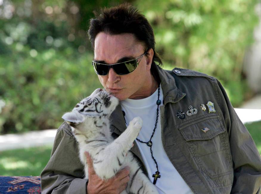 Roy Horn, of the illusionist team of Siegfried & Roy, kisses a 6-week-old, white-striped tiger ...