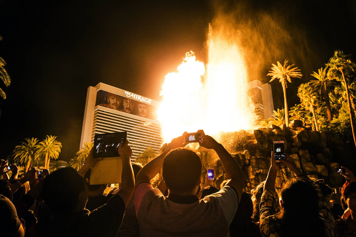 A large crowd gathers to watch the volcano erupt at The Mirage on the Strip on Tuesday, Oct. 11 ...