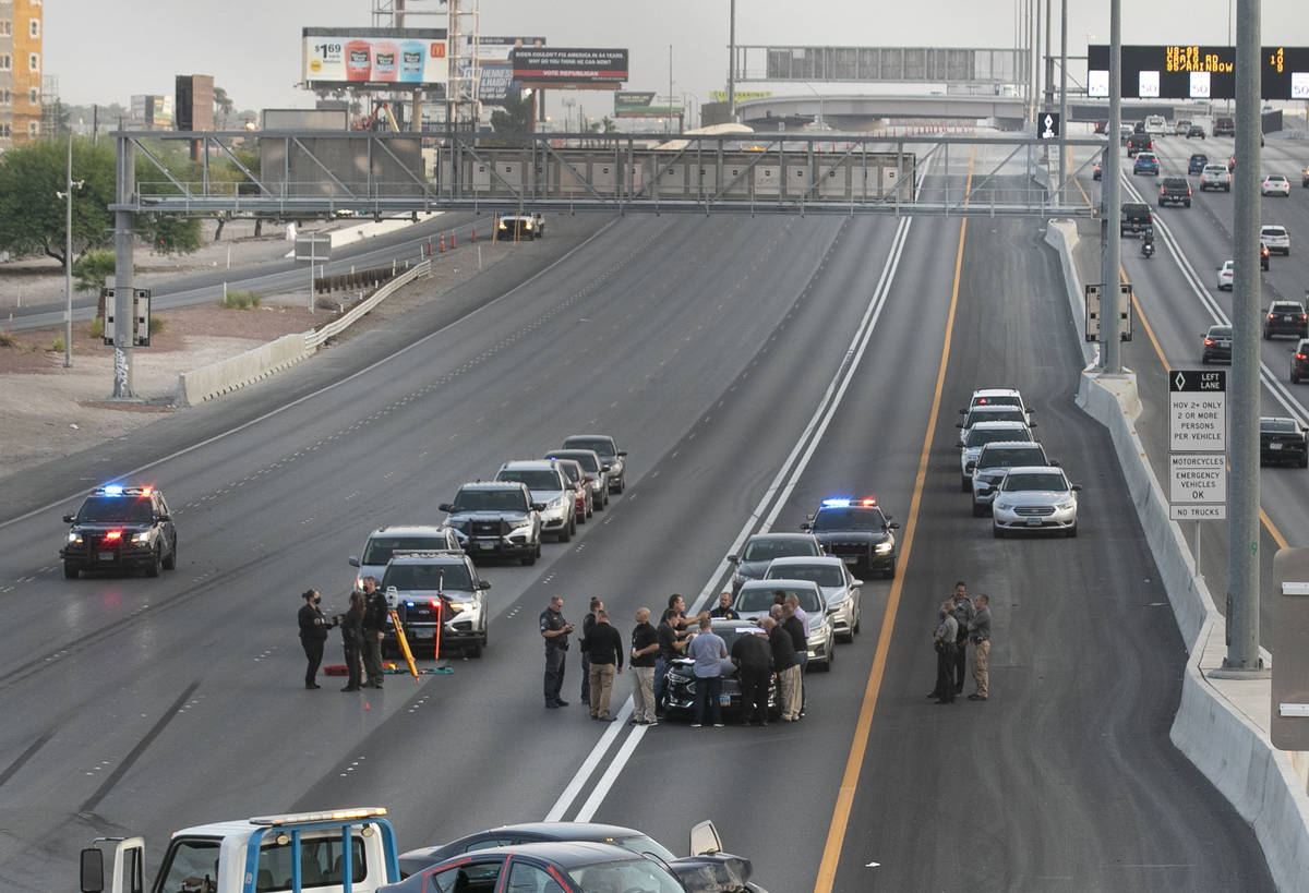 A team of officers and detectives investigates a fatal crash involving a shooting on southbound ...