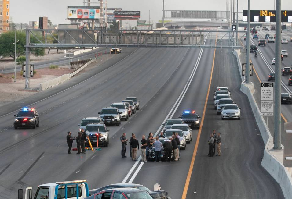 A team of officers and detectives investigates a fatal crash involving a shooting on southbound ...