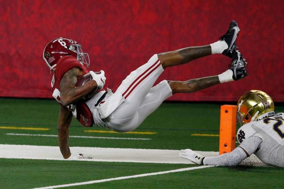 Alabama wide receiver DeVonta Smith (6) leaps into the end zone or a touchdown after getting pa ...