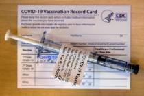 A pre-loaded shot and record card as some of the first veterans locally get their COVID-19 vacc ...