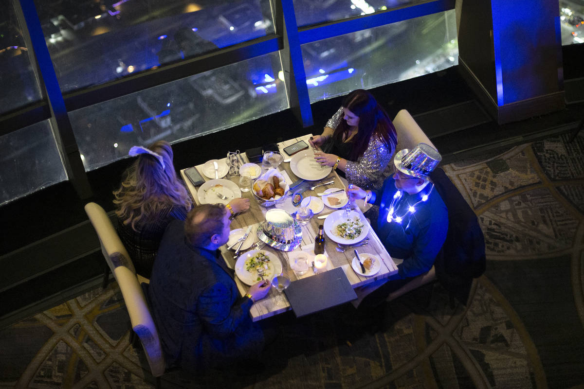 Diners enjoy at New Year's Eve dinner at the Top of the World restaurant at The STRAT on Thursd ...